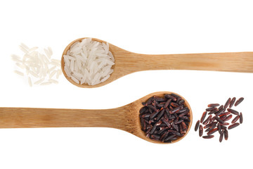 white and black rice grains in wooden spoon isolated on white background. Top view. Flat lay