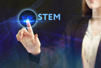 The concept of business, technology, the Internet and the network. A young entrepreneur working on a virtual screen of the future and sees the inscription: STEM