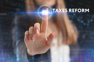 The concept of business, technology, the Internet and the network. A young entrepreneur working on a virtual screen of the future and sees the inscription: taxes reform