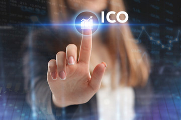 The concept of business, technology, the Internet and the network. A young entrepreneur working on a virtual screen of the future and sees the inscription: ICO