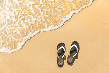 Flip-flops on a sandy ocean beach, Summer relax vacation holiday concept.