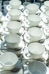 Abstract blurred many rows of coffee tea cups with coffee dispenser