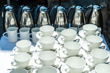 Abstract blurred many rows of coffee tea cups with coffee dispenser