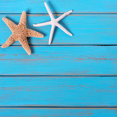 Fototapeta na wymiar Starfish old worn blue beach wood deck background border