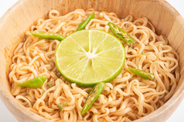 Wooden bowl of noodles isolated on white background