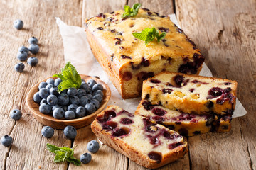 summer loaf of fresh blueberry muffin bread cake decorated with mint closeup. horizontal - Powered by Adobe