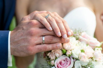 Obraz na płótnie Canvas hands groom and bride with wedding rings celebration love symbol