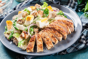 Healthy caesar salad with chicken, eggs and croutons