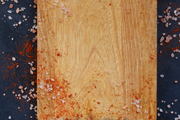 wooden cutting board and flakes of salt and red pepper. food cuisine cooking and eating concept. copyspace