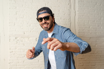 Naklejka premium young good looking latin man blogger talking to camera on white background