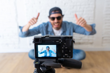 Obraz premium young happy blogger close up on camera screen
