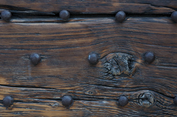 part of an ancient wooden door with hammered huge nails