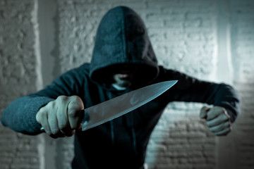 close up of man holding knife in knife crime concept photo