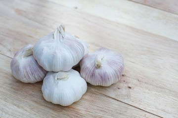 Fresh raw garlic on wooden table, copy space, kitchen raw ingredient concept