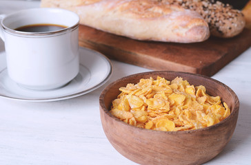 Bowl with cereals, bread and coffee