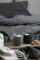 Two coffee mug in dark grey bed