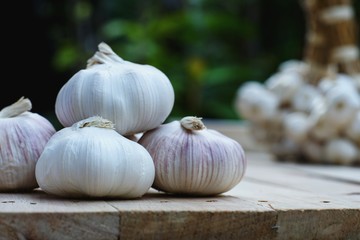 Fresh raw garlic on wooden table, copy space, kitchen raw ingredient concept