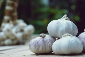 Fresh raw garlic on wooden table, copy space, kitchen raw ingredient concept