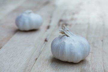 Fresh raw garlic on wooden table, copy space, kitchen raw ingredient concept