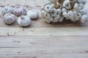 Fresh raw garlic on wooden table, copy space, kitchen raw ingredient concept