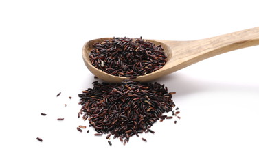 Organic black rice in wooden spoon isolated on white background   