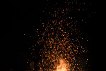 bonfire spark in the dark sky in night, shallow focus