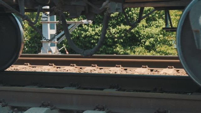 The wheels of the train by rail. Wagons move on rails