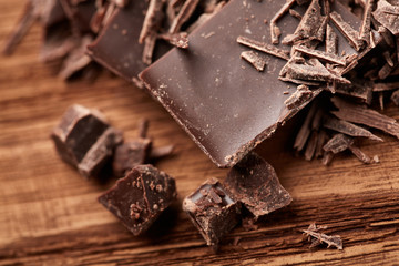 crumbs of black chocolate on a wooden background