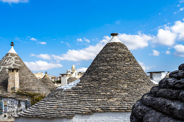 Fototapeta na wymiar Close up on the typical trulli rooftops, composed of overlapping stone circles, Apulia, Italy