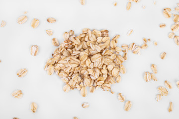 pile of oatmeal isolated on white background. Creative layout made of organic oatmeal isolated on white background. Food concept.