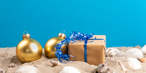 christmas balls and present at a beach