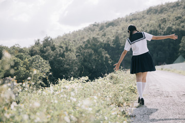 Portrait of asian japanese school girl costume looking at park outdoor film vintage style