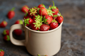 Fresh red strawberry on a dark abstract background. Summer berries. The concept of healthy eating.