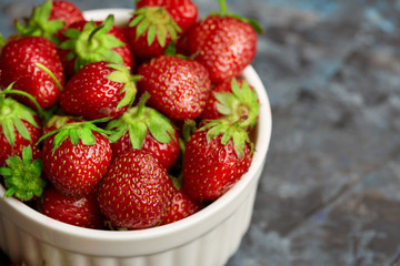 Fresh red strawberry on a dark abstract background. Summer berries. The concept of healthy eating.