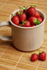 Fresh red strawberries on a wooden background. Summer berries. The concept of healthy eating.