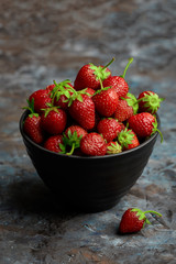 Fresh red strawberry on a dark abstract background. Summer berries. The concept of healthy eating.