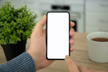 Male hands holding black touch phone with isolated screen