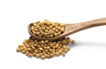 Integral roasted soybean flakes in wooden spoon isolated on white background