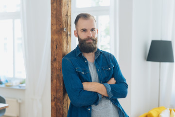 Relaxed confident young bearded man