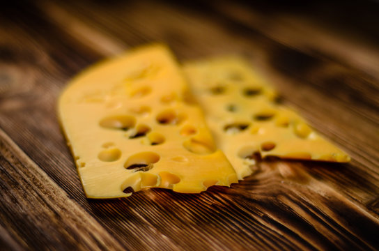 Sliced cheese on wooden table. Selective focus