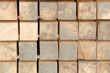 Naklejka premium Wooden beams stacked in a pile. Close-up