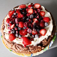 Homemade chocolate cake with white cream and berries