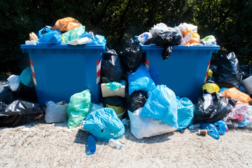 Overflowing Waste Collection Bins Outdoors