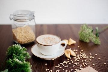 Cappuccino with nuts on the table.