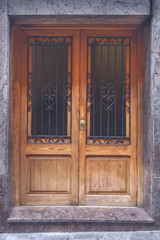 old wooden door, with trim metal ornaments closeup.