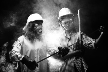 Two Beautiful Asian Architect Engineer women in hard hat, protector glasses goggle mask ear muff