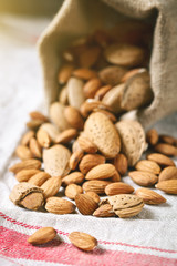 Almond on a wooden table in the summer garden. Useful food. Healthy lifestyle.