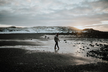 Person walking over a beach in Iceland
