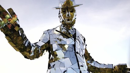 Woman with mirror costume covers the camera with his hand