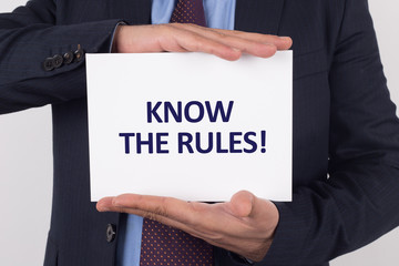 Man showing paper with KNOW THE RULES! text